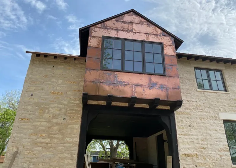 Copper metal panel facade on a stone building for Metal Roof Coating in Stillwater